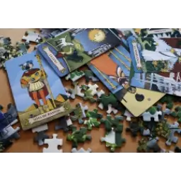 Jigsaw puzzle with a picture of a man and a woman on it, along with cards featuring pictures and text
